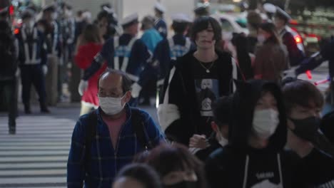 Cops-Controlling-The-Crowd-At-Shibuya-Crossing-During-The-Halloween-Night-In-Tokyo,-Japan---Medium-Shot