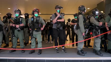 Policías-Antidisturbios-Montan-Guardia-Y-Filman-A-Miembros-De-La-Prensa-Y-Manifestantes-Cerca-Del-Edificio-Del-Consejo-Legislativo,-Conocido-Como-Legco,-En-Almirantazgo,-Hong-Kong