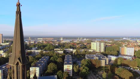 A-sliding-church-tower-and-a-visible-view-of-the-city-with-trees-and-houses