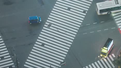 High-Angle-Top-Down-Super-Long-Tele-Shot-of-Traffics-at-the-Famous-Shibuya-Crossing-at-Night-in-Shibuya,-Real-Time