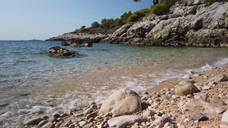 View-of-the-rocks,-pebbles,-and-clear-waters-of-Barjoska-Beach-on-the-island-of-Vis-in-Croatia