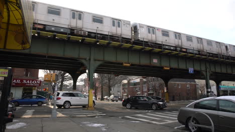 Early-Morning-Commuters-Move-Through-Queens-in-Winter,-Subway-Cars-Pedestrians