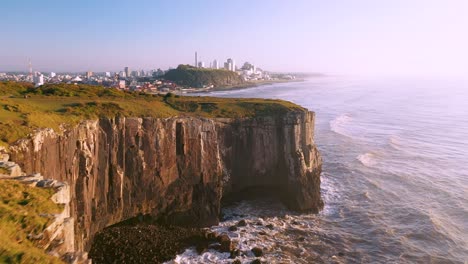 Establishing-beautiful-aerial-cinematic-shot-of-cliffs-on-atlantic-ocean,-Guarita-Park,-Brazilian-Conservation-Unit-in-Torres,-Rio-Grande-do-Sul