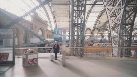 Dresden-train-station-Looking-out-the-window-of-a-train-at-people-sitting-at-a-railway-station-waiting-for-their-train,-Dresden,-Germany