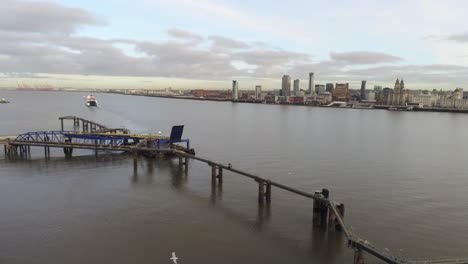 Stena-Line-logistics-ship-leaving-terminal-aerial-descend-view-Birkenhead-Liverpool-harbour-city-landscape