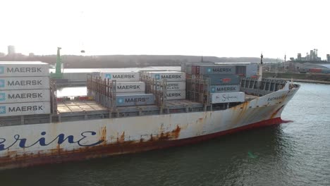 Huge-old-and-rusty-container-ship-leaving-Antwerp-harbor