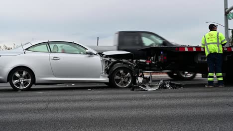 Crashed-car-in-street-with-tow-truck