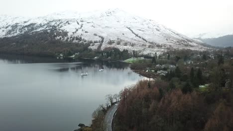 Pan-up-Snowy-Loch-Lomond-mountains-|-Drone