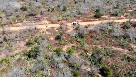 Vehicles-parked-on-a-dirt-track,-Aerial-drone-view