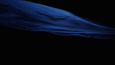 Blue-Silk-Cloth-Flying-In-Black-Background---studio-shot