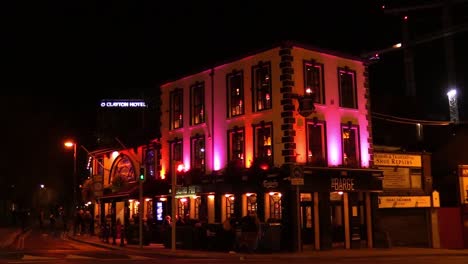 Still-video-of-people-and-cars-passing-by-on-a-street-in-front-of-a-bar-or-pub-in-Dublin-City