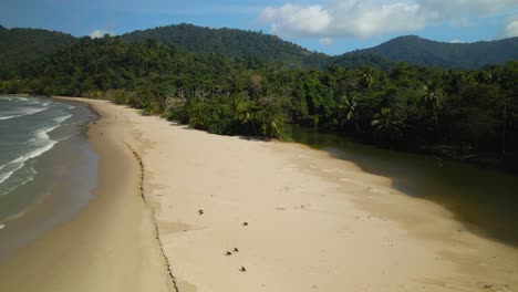 Low-flying-aerial-view-of-Las-Cuevas-Bay-as-the-river-flows-into-the-sea-on-this-tropical-island-Trinidad