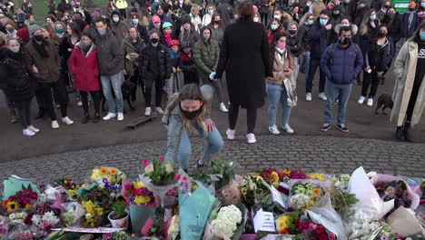 Während-Einer-Mahnwache-Für-Sarah-Everard,-Die-Entführt-Und-Ermordet-Wurde,-Kommen-Leute-Nach-Vorne-Und-Legen-Blumen-An-Einem-Denkmal-Am-Musikpavillon-Von-Clapham-Nieder