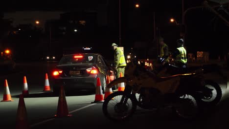 Military-Men-Talking-And-Checking-The-Declaration-Border-Pass-Of-A-Driver-Inside-A-Black-Car---Gold-Coast-Border-Restrictions-During-Pandemic--Queensland,-Australia---wide-shot