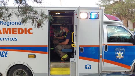 Paramedic-service-car-doors-open-man-drink-take-mask-off