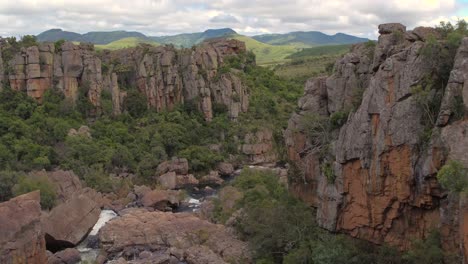 Drone-Aerial-Reveal-shot-near-Blyde-river-canyon-at-the-Amber-'Treur'-Falls-in-Mpamalunga,-South-Africa