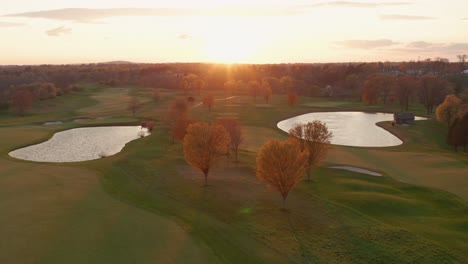 Descending-pedestal-shot-at-beautiful-country-club,-golf-course-at-sunset,-sunrise