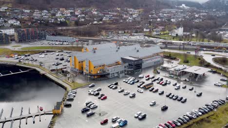 Closeup-over-the-roof-of-Oyrane-Torg-shopping-centre,-Arna-railway-station-and-local-road-leading-to-Garnes---Bergen-Norway