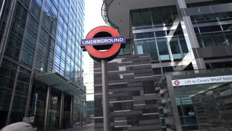 POV-walking-through-Canary-Wharf,-London-in-streets-with-people