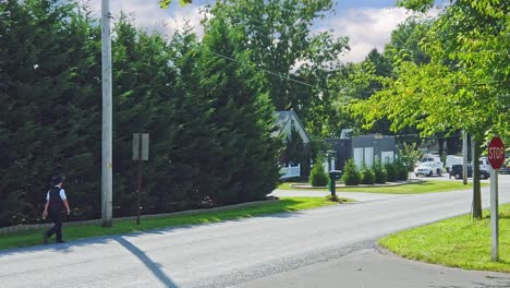 An-Amish-Boy-Walking-Along-a-Country-Road-on-a-Sunny-Day-in-Slow-Motion