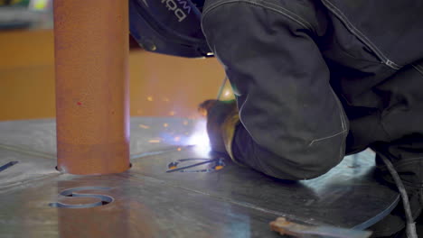 Cropped-View-Of-A-Male-Welder-In-Protective-Gear-Welding-Metal-Table