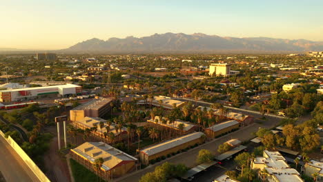 Hotel-Tucson-with-Santa-Catalina-Mountains-in-background-at-sunset,-drone-view