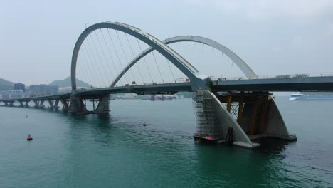 Hong-Kong-cross-bay-link-construction-project,-a-dual-two-lane-bridge-connecting-Tseung-Kwan-O-Lam-Tin-Tunnel-to-Wan-Po-Road,-Aerial-view