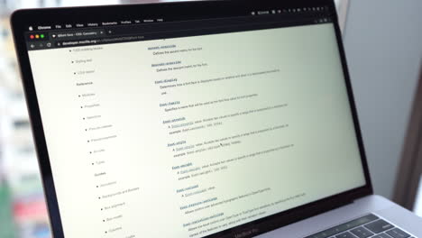 Scrolling-And-Reading-Through-MDN-Web-Docs-Page-On-Laptop-Screen
