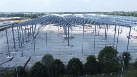Construction-industry-metal-iron-girder-warehouse-framework-construction-site-aerial-view-rise-above-structure