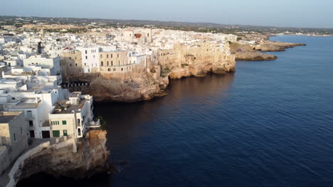 Houses-and-cliffs-of-the-beautiful-coastal-town-of-Polignano-a-Mare,-drone