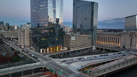 Rising-aerial-of-skyscrapers-and-FMC-buildings,-30th-St-Train-Station-at-sunrise