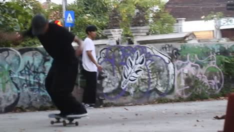 Boys-practice-skateboarding-in-an-abandoned-building-in-Denpasar,-Bali,-October-25,-2021