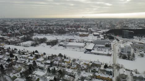 Sideways-moving-aerial-view-of-Turku-cityscape-in-winter-time-after-snowfall-when-everything-is-covered-in-snow