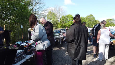 Bargain-hunters-shopping-at-busy-British-weekend-car-boot-sale-for-unwanted-goods