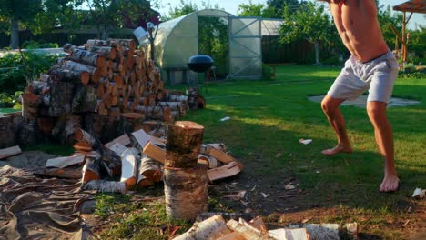 Shirtless-Man-Chopping-Firewoods-With-Full-Force