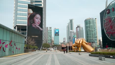 Toma-De-Establecimiento-De-La-Estatua-De-Las-Manos-Doradas-De-Gangnam-En-El-Complejo-Comercial-Coex-Mirando-Hacia-La-Calle-Yeongdong-daero