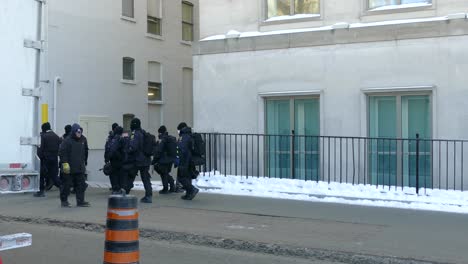Un-Gran-Grupo-De-Policías-Canadienses-Caminando-Por-La-Acera-Durante-El-Convoy-De-Libertad,-Protesta-Covid-19