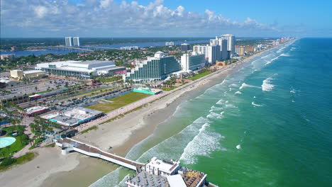 Drone-flying-away-from-Daytona-Beach-shore-revealing-coastline-vista
