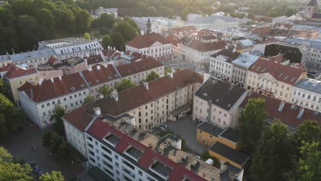 Drone-shot-over-Tartu-downtown-during-summer-time,-beautiful-red-rooftops-and-historical-buildings