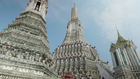 4K-Cinematic-religious-travel-scenic-footage-of-the-Buddhist-temple-of-Wat-Arun-in-the-old-town-of-Bangkok,-Thailand-on-a-sunny-day