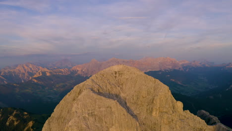 Breath-taking-golden-hour-sunrise-aerial-view-orbiting-above-South-Tyrol-Plose-Peitlerkofel-epic-mountain-peak-landscape