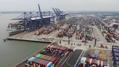 A-shipping-container-is-unloaded-at-the-docks-in-Felixstowe,-Suffolk,-UK