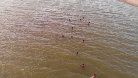 Aerial-Circle-Dolly-View-Of-Male-Rescuers-Swimming-For-Flood-Rescue-Training-In-Balochistan