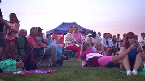 People-outdoors-listening-to-the-concert-and-having-good-time