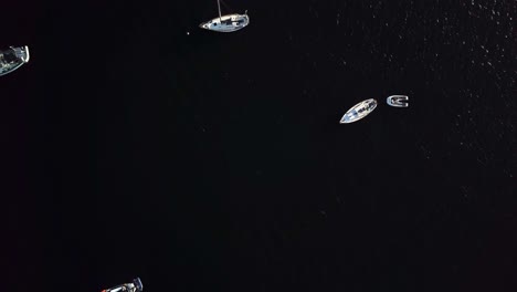 Dolly-in-overhead-view-of-luxury-boats-and-yachts-on-the-shore-of-Spaanse-Water-village-on-the-Dutch-island-of-Curacao,-Caribbean-Sea