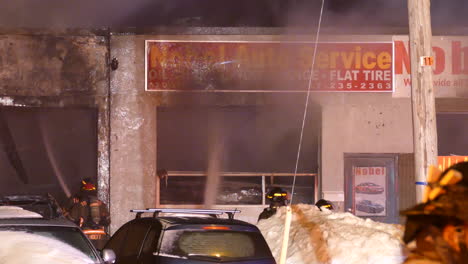 Toronto-firemen-extinguishing-fire-in-auto-service-shed-at-night