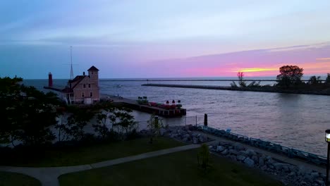 Drone-lift-to-show-the-sun-setting-over-the-Lake-Michigan-coast-line