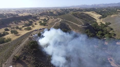 AERIAL---Firefighters-stop-a-fire-from-the-top-of-the-hill
