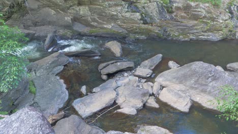 Freshwater-Creek-Flowing-Through-Rocks-In-Rainforest