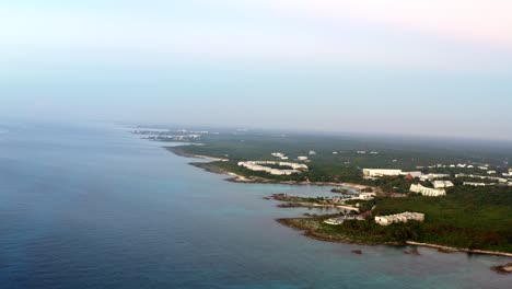 Beautiful-aerial-drone-bird's-eye-view-of-the-stunning-playa-del-carmen-beach-coastline-with-various-resorts-along-it-on-a-colorful-vivid-summer-morning-during-sunrise-in-Riviera-Maya,-Mexico
